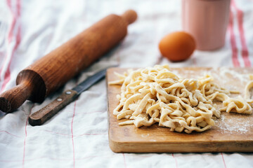 homemade noodles on a cutting board with flour