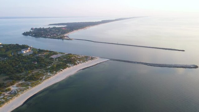 Aerial view of a channel into the sea with Baltic spit in Baltiysk, Kaliningrad region, Russia on Baltic sea at sunset. 4k drone video