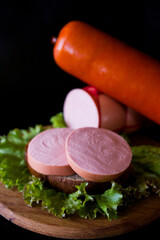 sausage and salad. meat and sausage. Cooked sausage. Pieces of sausage on black bread. 