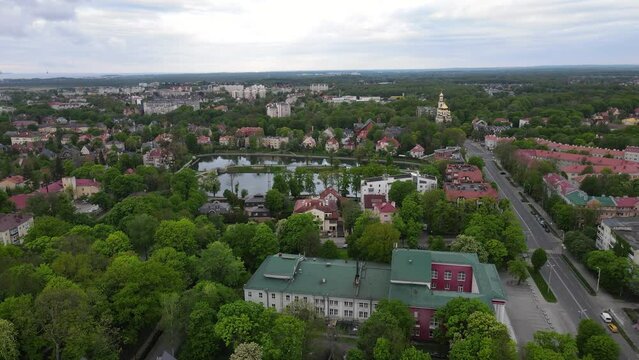 Aerial cityscape of old town with buildings, lake and church in Amalienau district, Kaliningrad, Russia. 4k drone video
