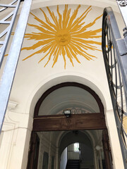 Large yellow sunshine above the front entranceway 