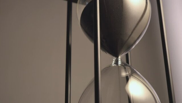 Vintage style hourglass with sand flow, inevitable change,life,  business, money, investment.
