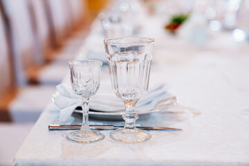 empty glasses on the served festive table. etiquette and serving lessons. restaurant and catering services.