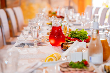 salads, snacks, drinks and glasses on the served festive table. restaurant and catering services. etiquette and serving lessons.