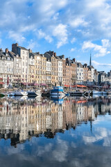Fototapeta premium Honfleur, beautiful city in France, the harbor in the morning, reflection on the river 