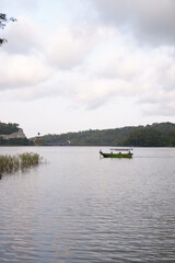 Fototapeta na wymiar boat on the river boat on the river or perahu di waduk sermo, yogyakarta, indonesia