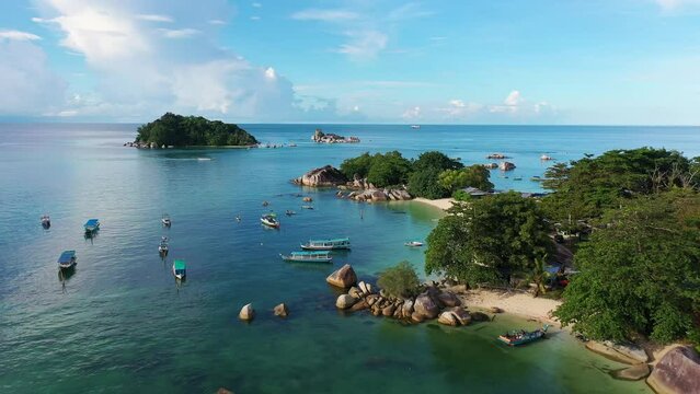 Belitung, Indonesia: Aerial drone footage of the stunning Kelayang beach and island with dramatic rocks in Belitung in the Java sea in Indonesia. Shot with a forward and rotation motion. 