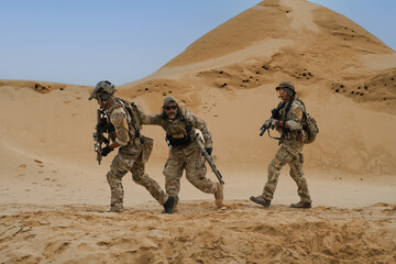 Group army ranger special force on the desert battle field on patrol walk with armforce standby...