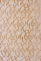 Vintage stucco ornate of beige colour on the wall outside on the street of Segovia, Spain