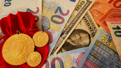 Top view photo of money, euro, dollar and gold coins on the red background.