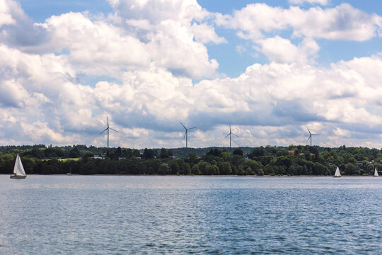 Wind Turbines from Berg. Yachting on Lake Stanberg. Cloudy Lake Landscape.