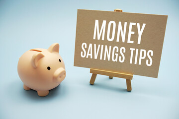 Money saving tips text messege and piggy bank on blue background