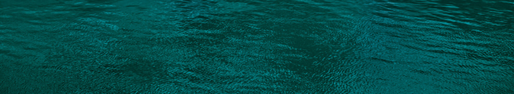 Blue green water surface. Ripples. Reflection. Little waves. Dark teal water background with space for design. Web banner. Website header. © Наталья Босяк