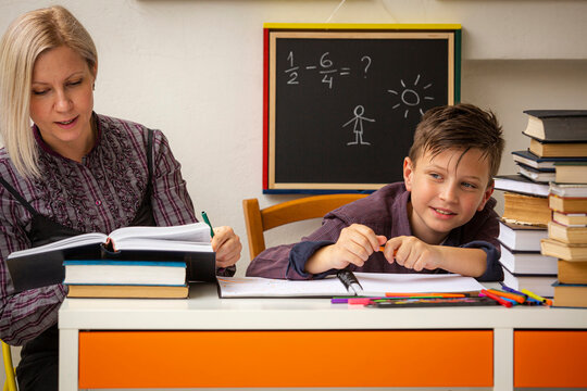 A Junior High School Student Studies At Home With A Female Tutor.