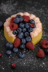 Cake with cream covered with juicy berries.