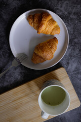 Homemade croissants on old table background.