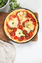 Pepperoni pizza on light background.