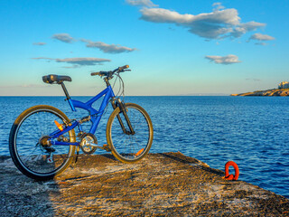 Blue mountain bike at the end of pier. Rafina city , Greece