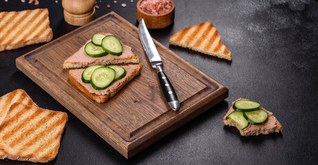 Delicious fresh sandwich with chicken liver pate with crispy toast, butter and cucumber - obrazy, fototapety, plakaty
