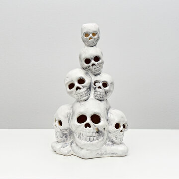 Stack of human decorative skulls for Halloween decoration on white. Party decoration. Happy Halloween