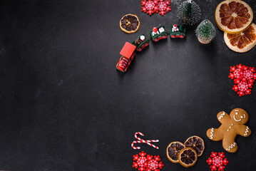 Delicious fresh chocolate biscuits on a dark concrete background with Christmas toys
