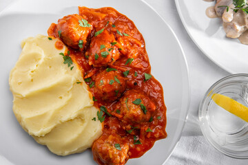Mashed potatoes with meat balls in sauce