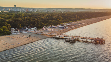Fototapeta premium View of the beach and pier in Brzeźno, Gdańsk at sunset. Summer 2022.