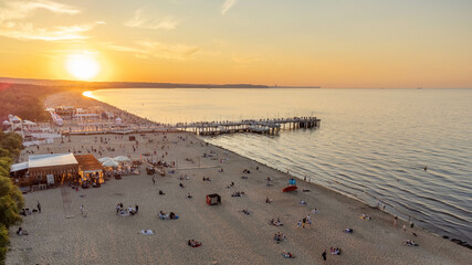 View of the beach and pier in Brzeźno, Gdańsk at sunset. Summer 2022.