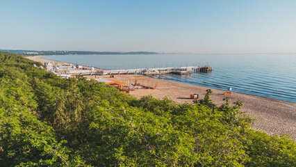 View of the beach and pier in Brzeźno, Gdańsk at sunrise. Summer 2022.

