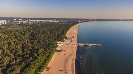 View of the beach and pier in Brzeźno, Gdańsk at sunrise. Summer 2022.

