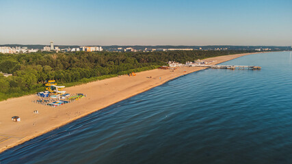 View of the beach and pier in Brzeźno, Gdańsk at sunrise. Summer 2022.  