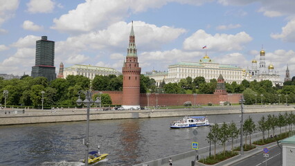 Obraz premium MOSCOW, RUSSIA - MAY 22, 2022: View of the Moscow Kremlin from the Moscow river. Red brick towers and Bell Tower Of Ivan The Great