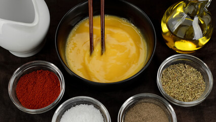 Cooking traditional omelette. Scrambled eggs, omelette. Whisking eggs. Traditional heathy breakfast.