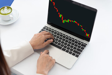 Young woman with stock market bar chart on computer screen.