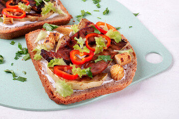 Bruschetta with grilled zucchini, corn, mushrooms, pepper and salad leaves on whole grain toasted bread. Sandwich with grill vegetables