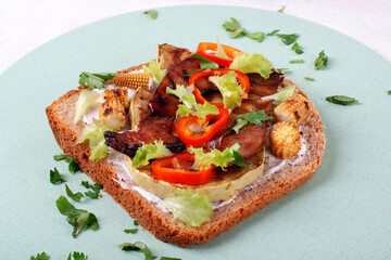 Bruschetta with grilled zucchini, corn, mushrooms, pepper and salad leaves on whole grain toasted bread. Sandwich with grill vegetables