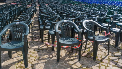 Vacant empty plastic chairs pattern. A lot of chairs for spectators. Comfortable furniture for events.