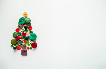 Apple tree or Christmas tree made of buttons green, red color. White background, Copy space