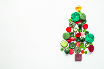 Apple tree or Christmas tree made of buttons green, red color. White background, Copy space