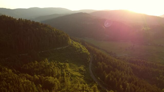 Aerial drone footage of flight over mountains in the Black Forest in Southern Germany at sunset