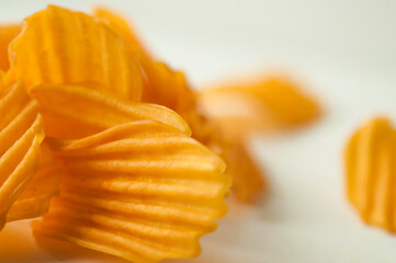 Obraz na płótnie Canvas close-up, golden yellow, sweet potato chips, white background