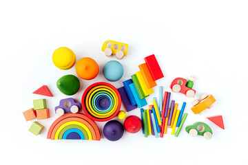 Colorful wooden toys in the colors of the rainbow on white background.  Games for learning and...