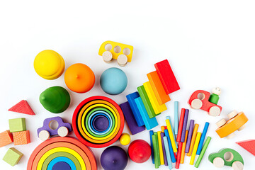 Colorful wooden toys in the colors of the rainbow on white background.  Games for learning and development of the child. Cute kids toys to play and for decorating children's room.
