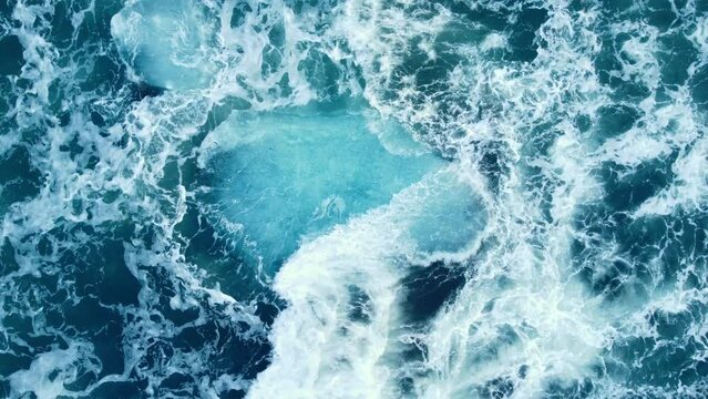 Iceberg huge chunks of blue Ice floating on the waves in the ocean beautiful arctic landscape aerial top view