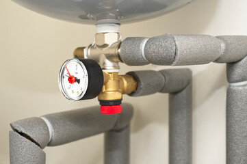 Pressure gauge on domestic boiler expansion vessel inside house
