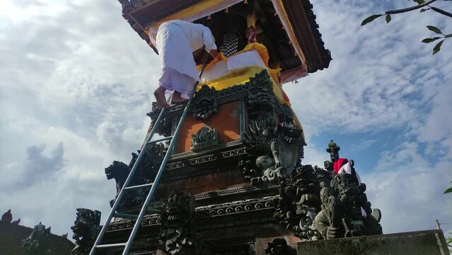 Someone who climbs up to Bale Kulkul, Bale Kulkul or Bale Kul-Kul is a Balinese pavilion where a slit-log drum is placed.