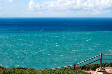 Fototapeta premium Cabo da Roca in Portugal. The westernmost point of Europe. Cliffs and rocks on the Atlantic ocean coast in Sintra. Travel, explore, hiking and vacation concept