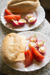 Bun with cheese, tomatoes, radishes with butter 