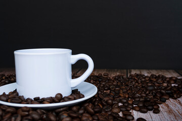 Cup of coffee on coffee beans background.