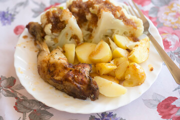 Roasted chicken legs with cauliflower and potatoes 